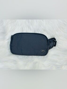 Minimalist Black Women's Belt Bag with Subtle Metal Emblem